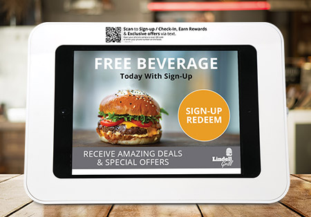 a point of sale tablet with a free beverage offer displayed