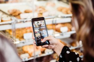 taking photo of bakery display with phone